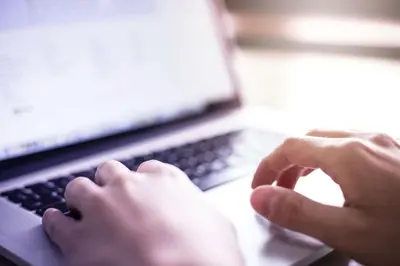 a person is typing on a laptop computer at La Quinta by Wyndham Cleveland Macedonia in Macedonia