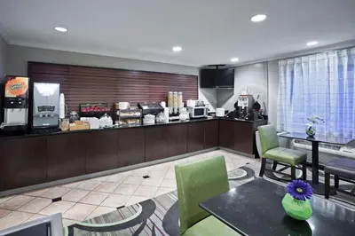 a kitchen with a table and chairs in a room at La Quinta by Wyndham Cleveland Macedonia in Macedonia