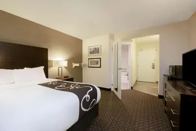 a hotel room with a bed and a flat screen tv at La Quinta by Wyndham Cleveland Macedonia in Macedonia