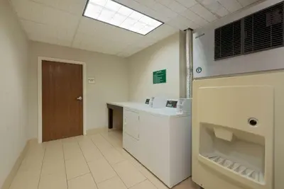a hospital room with a sink and a toilet at La Quinta by Wyndham Columbus - Grove City in Grove City