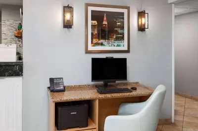 a desk with a computer and a phone on it at La Quinta Inn by Wyndham Cleveland Independence in Independence
