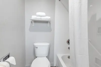 a white bathroom with a toilet and a shower at La Quinta Inn by Wyndham Cleveland Independence in Independence