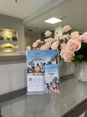 a sign sitting on top of a table with pink roses at La Quinta Inn and Suites by Wyndham Cincinnati North in Springdale