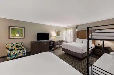 a hotel room with two beds and a bunk bed at Comfort Inn & Suites Tipp City Dayton North I-75 in Tipp City