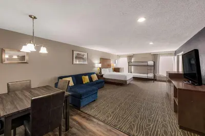a hotel room with a bed and a living room at Comfort Inn & Suites Tipp City Dayton North I-75 in Tipp City