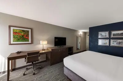 a hotel room with a bed and a desk with a computer at Comfort Inn & Suites Tipp City Dayton North I-75 in Tipp City
