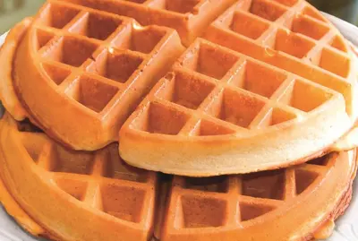 a stack of waffles on a white plate at La Quinta by Wyndham Cincinnati NE - Mason in Mason