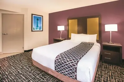 a large bed in a hotel room with two lamps at La Quinta by Wyndham Cincinnati NE - Mason in Mason