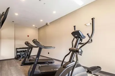 a gym with three exercise bikes in a room at Sleep Inn & Suites Mt Hope near Auction & Event Center in Millersburg