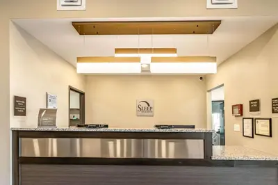 a lobby of a hospital with a reception counter at Sleep Inn & Suites Mt Hope near Auction & Event Center in Millersburg