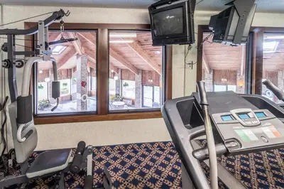 a gym with a treadmill and a tv in it at Quality Express Inn & Suites in Mineralwells