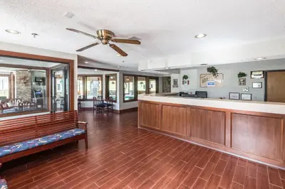 a lobby with a bar and a ceiling fan at Quality Express Inn & Suites in Mineralwells