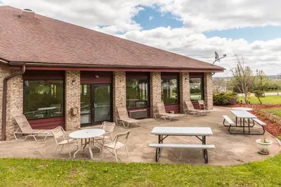 a patio with tables and chairs in front of a building at Quality Express Inn & Suites in Mineralwells