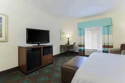 a hotel room with a bed and a flat screen tv at Hampton Inn & Suites Wheeling - The Highlands in Triadelphia