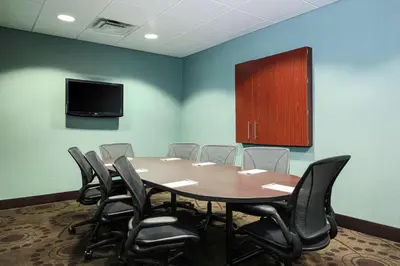 a conference room with a table and chairs and a tv at Hampton Inn & Suites Wheeling - The Highlands in Triadelphia