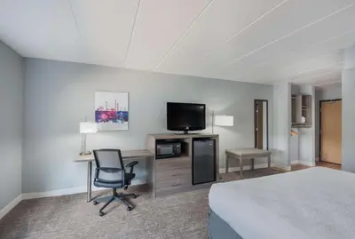 a hotel room with a bed and a desk and a television at Best Western Fort Wayne I-69 North in Fort Wayne