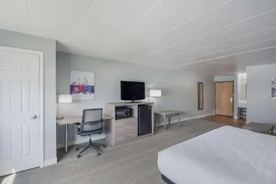 a bedroom with a bed and a desk and a tv at Best Western Fort Wayne I-69 North in Fort Wayne
