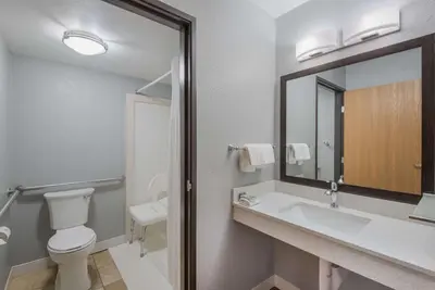 a bathroom with a sink and a toilet and a mirror at Best Western Fort Wayne I-69 North in Fort Wayne