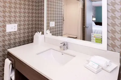 a bathroom with a sink and a mirror at Home2 Suites By Hilton New Albany Columbus in New Albany