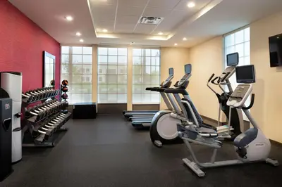 a gym with treadmills and ellipticals in a room at Home2 Suites By Hilton New Albany Columbus in New Albany