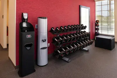 a fitness room with a rack of dumbbells at Home2 Suites By Hilton New Albany Columbus in New Albany