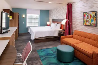 a hotel room with a bed and a couch at Home2 Suites By Hilton New Albany Columbus in New Albany