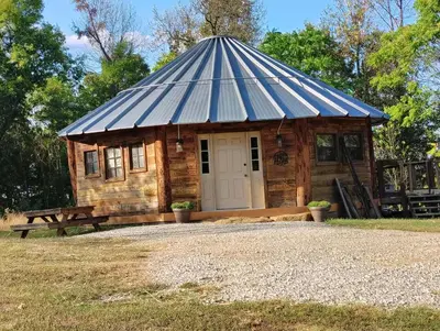 a small wooden cabin with a pitched roof at The Highlander - Rustic Mountain Yurt in Genoa