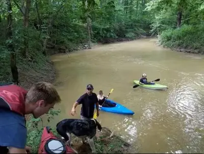 a group of people and a dog in a river at The Sandstone - A 3BR, 2BA Deluxe Log Cabin in Genoa