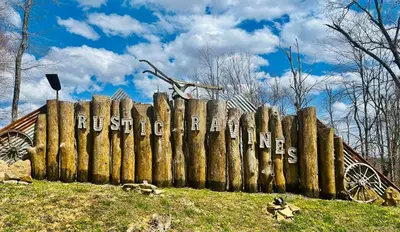 a wooden fence with the words russelletts written on it at The Sandstone - A 3BR, 2BA Deluxe Log Cabin in Genoa