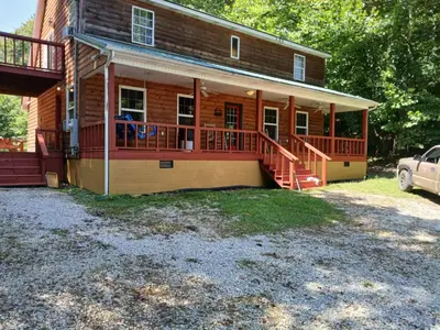 a home with a large deck on a house at The Bunkhouse - 3 BR, 2 BA Deluxe Cabin in Genoa