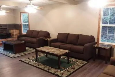 a living room with a couch and a coffee table at The Bunkhouse - 3 BR, 2 BA Deluxe Cabin in Genoa