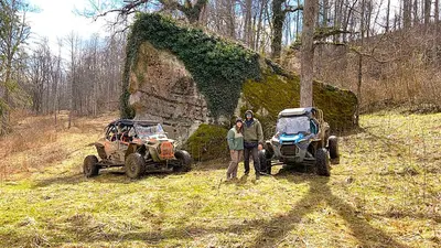 a man and a woman standing next to two atvs at The Bunkhouse - 3 BR, 2 BA Deluxe Cabin in Genoa