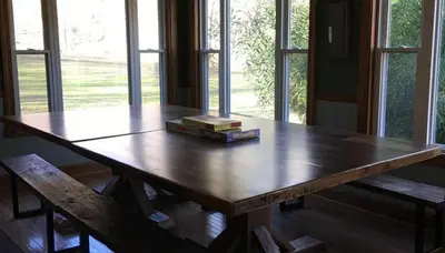 a wooden table with two books on top of it at The Lodge - Chestnut Log Cabin in Genoa