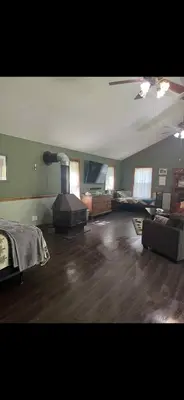 a large living room with a fireplace and a couch at The Lodge - Chestnut Log Cabin in Genoa