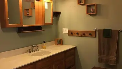 a bathroom with a sink and a mirror at The Lodge - Chestnut Log Cabin in Genoa