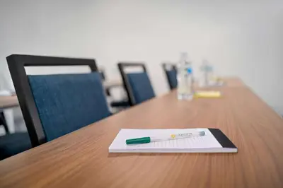 a pen sitting on top of a wooden table at La Quinta Inn by Wyndham Columbus Airport Area in Columbus