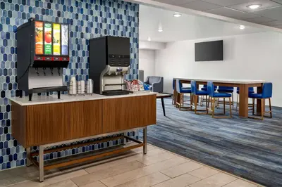 a waiting room at a hospital with chairs and tables at La Quinta Inn by Wyndham Columbus Airport Area in Columbus