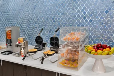 a white counter with a bowl of fruit on it at La Quinta Inn by Wyndham Columbus Airport Area in Columbus