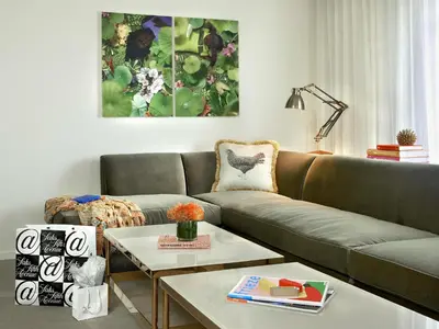 a living room with a couch and a table at 21c Museum Hotel Cincinnati in Cincinnati