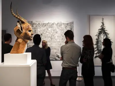 a group of people looking at a sculpture in a museum at 21c Museum Hotel Cincinnati in Cincinnati
