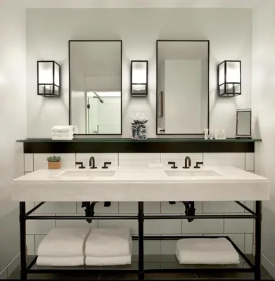 a bathroom with two sinks and two mirrors at 21c Museum Hotel Cincinnati in Cincinnati