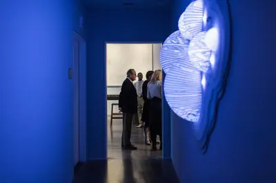 a group of people standing in a blue room at 21c Museum Hotel Cincinnati in Cincinnati