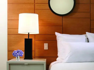 a lamp on a night stand next to a bed at 21c Museum Hotel Cincinnati in Cincinnati