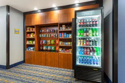 a soda refrigerator in a room with soda drinks at La Quinta by Wyndham Columbus West - Hilliard in Columbus