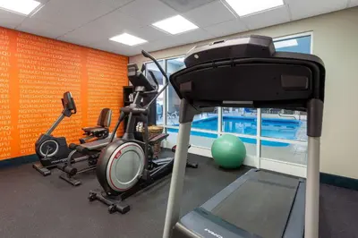 a gym with two exercise bikes and a treadmill at La Quinta by Wyndham Columbus West - Hilliard in Columbus