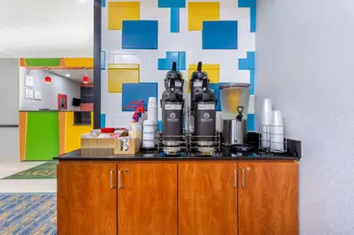 a counter with bottles of wine on top of it at La Quinta by Wyndham Columbus West - Hilliard in Columbus