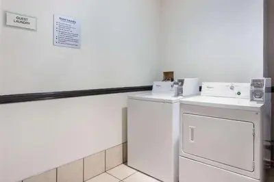 a laundry room with a washer and dryer at La Quinta by Wyndham Columbus West - Hilliard in Columbus