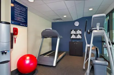 a gym with two treadmills and a ball and a treadmill at Hampton Inn Wooster in Wooster