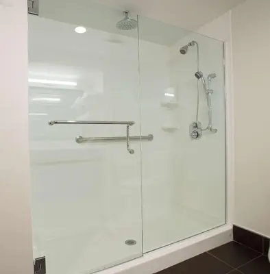 a shower with a glass door in a bathroom at Hampton Inn Wooster in Wooster