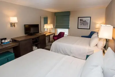 a hotel room with two beds and a television at Hampton Inn Wooster in Wooster